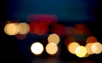 Explora nuestro impresionante fondo de pantalla de luces nocturnas en bokeh rojo