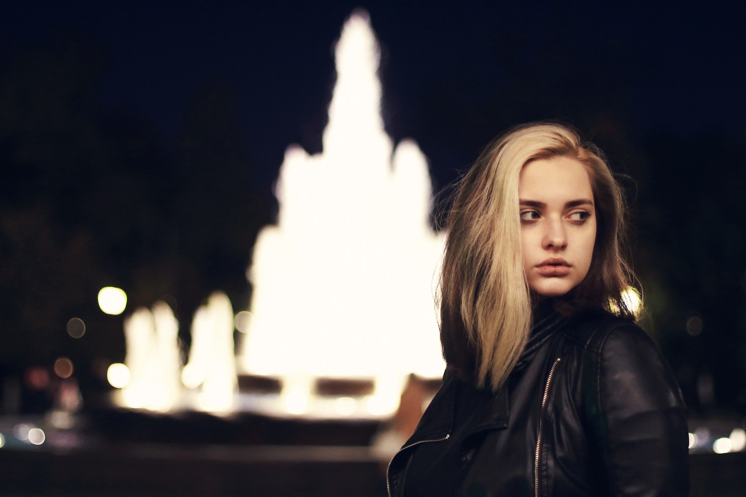 Nighttime Elegance: Blond Lady by the Fountain