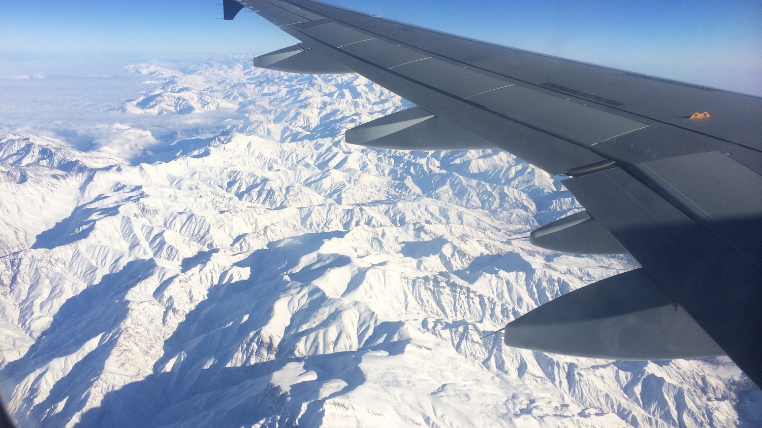 Breathtaking View of Snow-Capped Mountains from a Flight