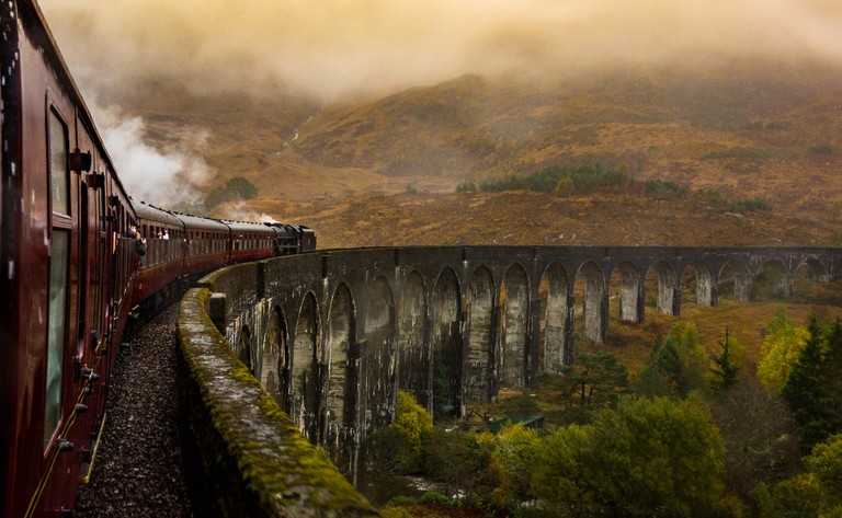 Highland Train Through Scenic Mountains Wallpaper