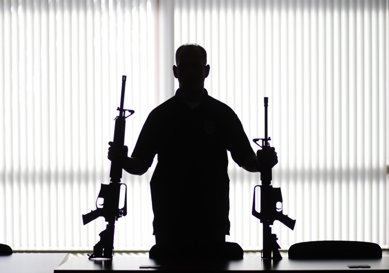 Dramatic Silhouette of a Musician Holding Firearms