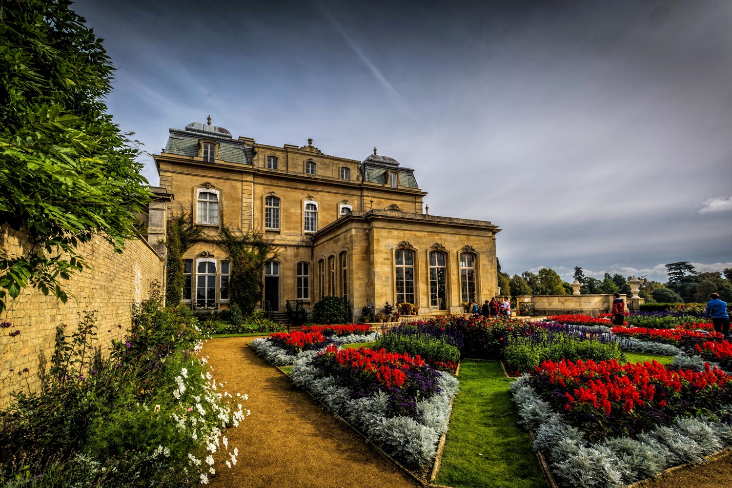 Breathtaking English Garden Wallpaper Featuring a Historic Estate