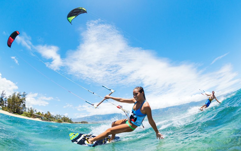 Experience the Thrill of Kitesurfing with Our Vibrant Wallpaper