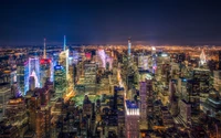 Explora la belleza de Manhattan de noche: descarga este increíble fondo de pantalla de skyline