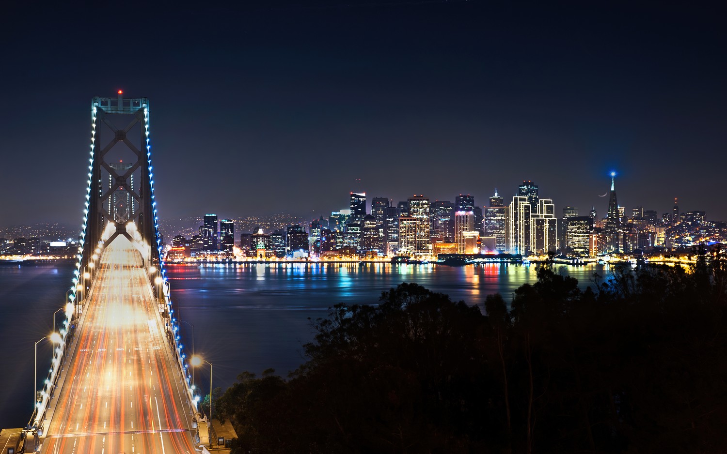 Experience the Beauty of San Francisco at Night with Our Oakland Bay Bridge Wallpaper