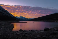 Breathtaking Sunset Over Mountain Lake Wallpaper