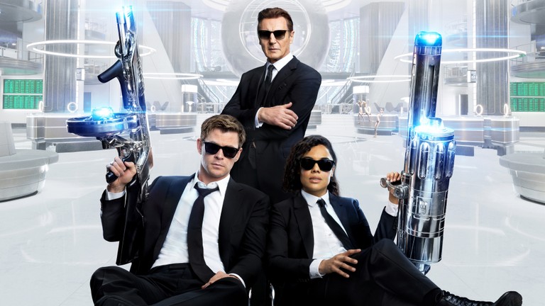 Download Men in Black International Wallpaper Featuring Liam Neeson, Chris Hemsworth, and Tessa Thompson