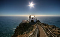 Download Breathtaking Lighthouse Overlooking the Ocean